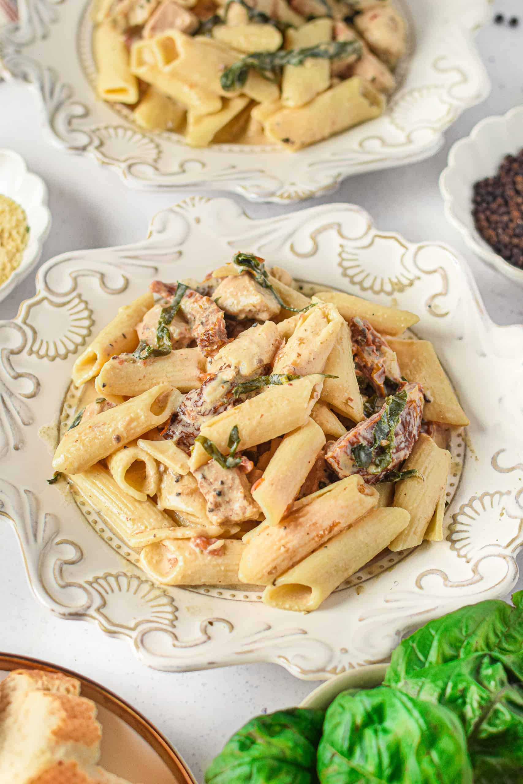 Instant Pot Tuscan Chicken Recipe served on white plates.
