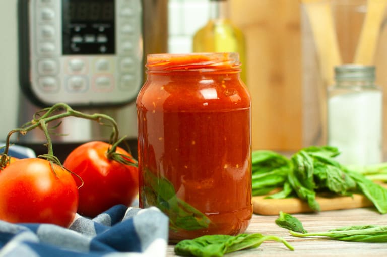 Headon view of tomato sauce in a jar.