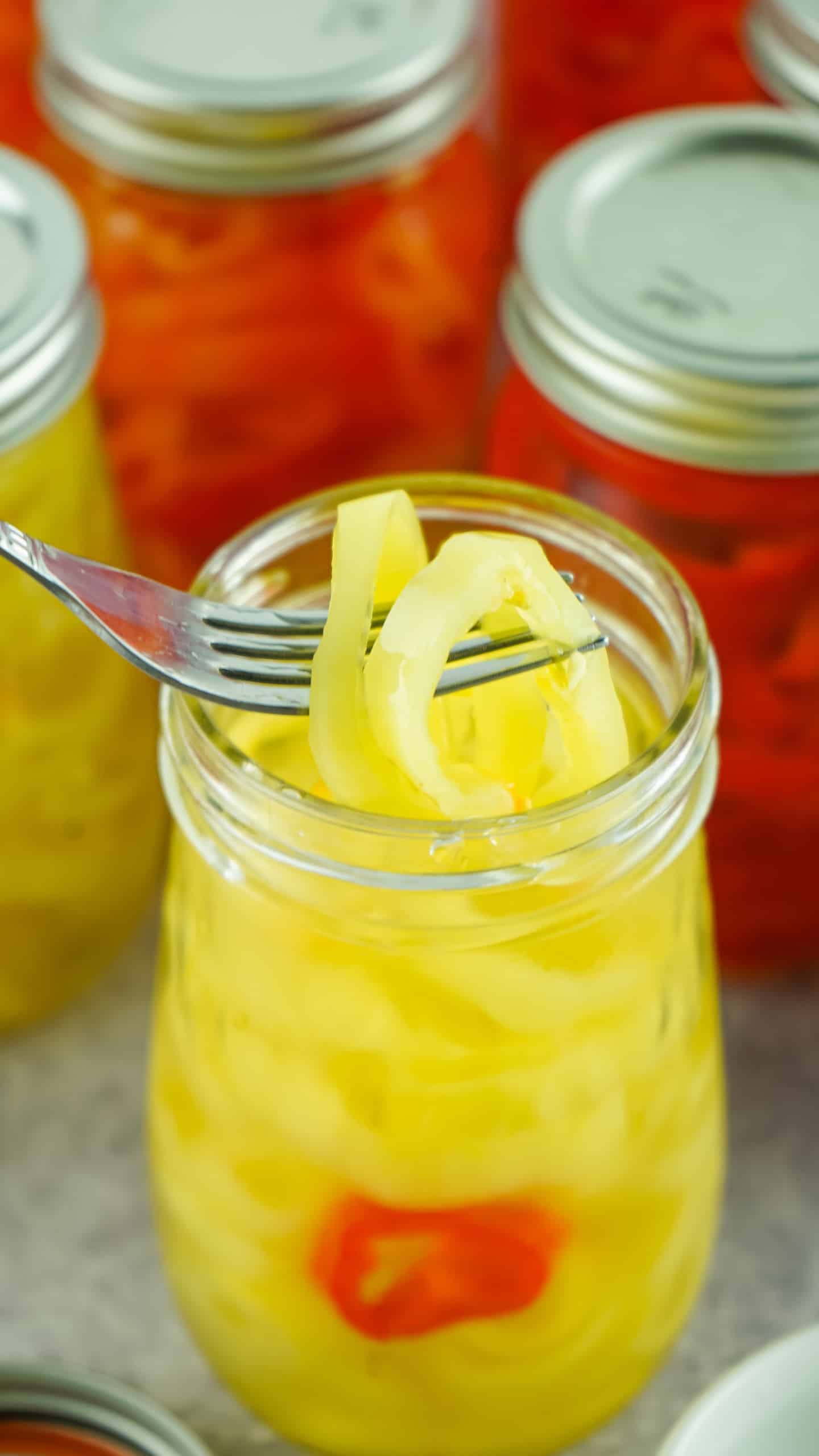 Pickled banana peppers on a fork.