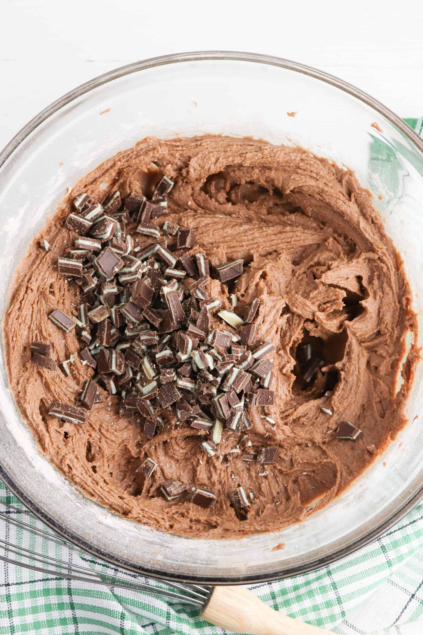Overhead view of chocolate cookie dough with Andes mints in it.