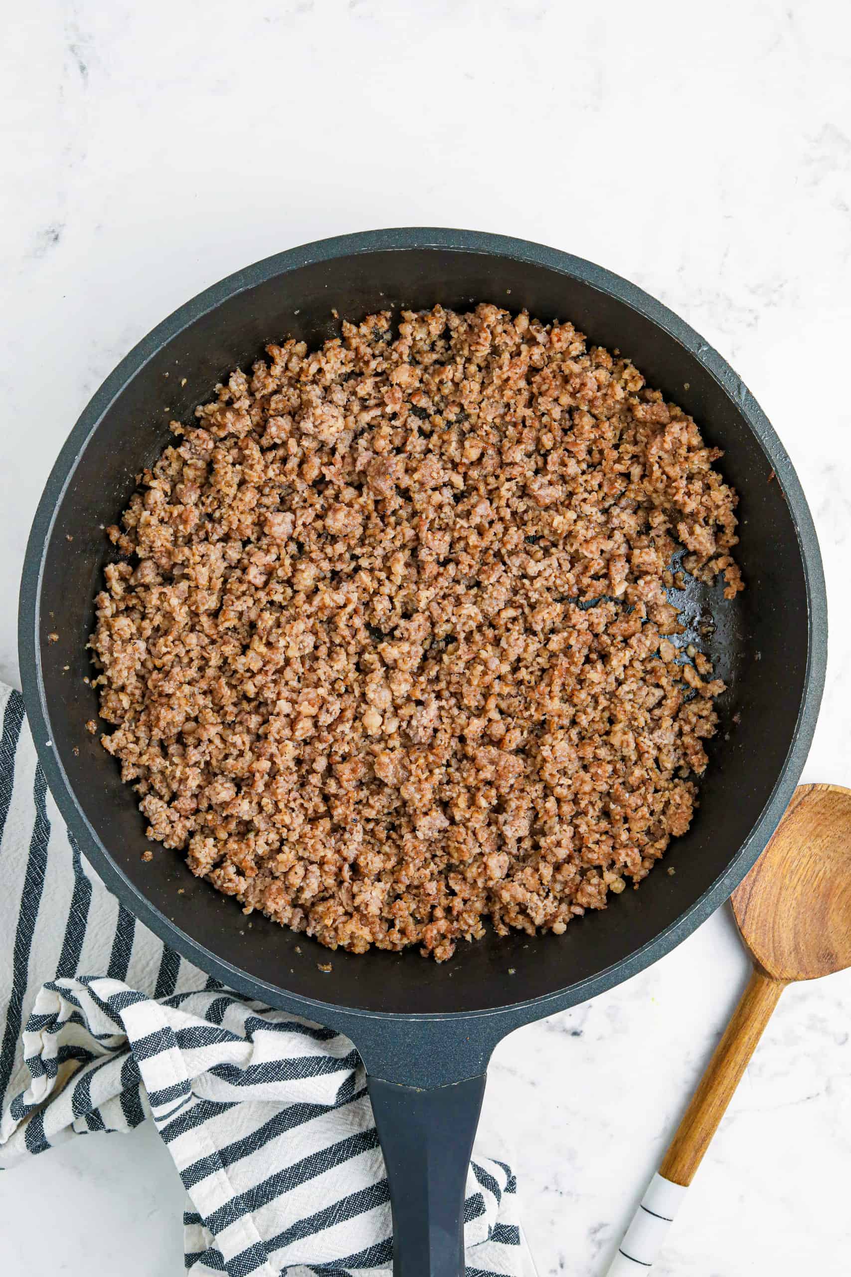 Browned sausage in a black cast iron skillet.