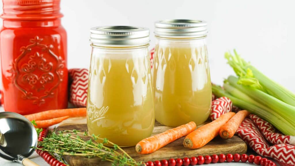2 Mason jars filled with turkey broth.