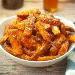Air fryer parm carrot fries in a white bowl.