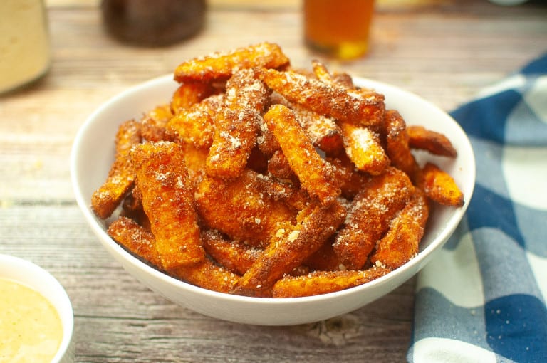 Air fryer parm carrot fries in a white bowl.