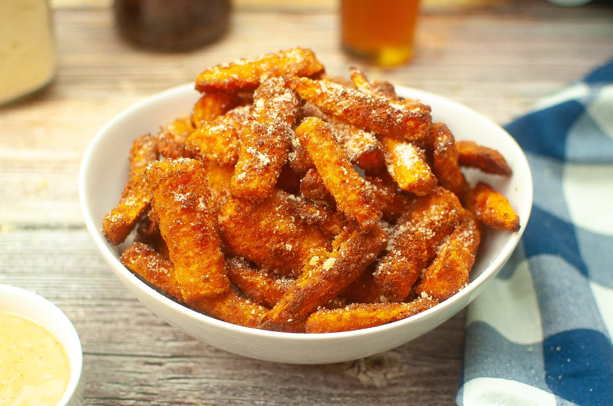 Air fryer parm carrot fries in a white bowl.