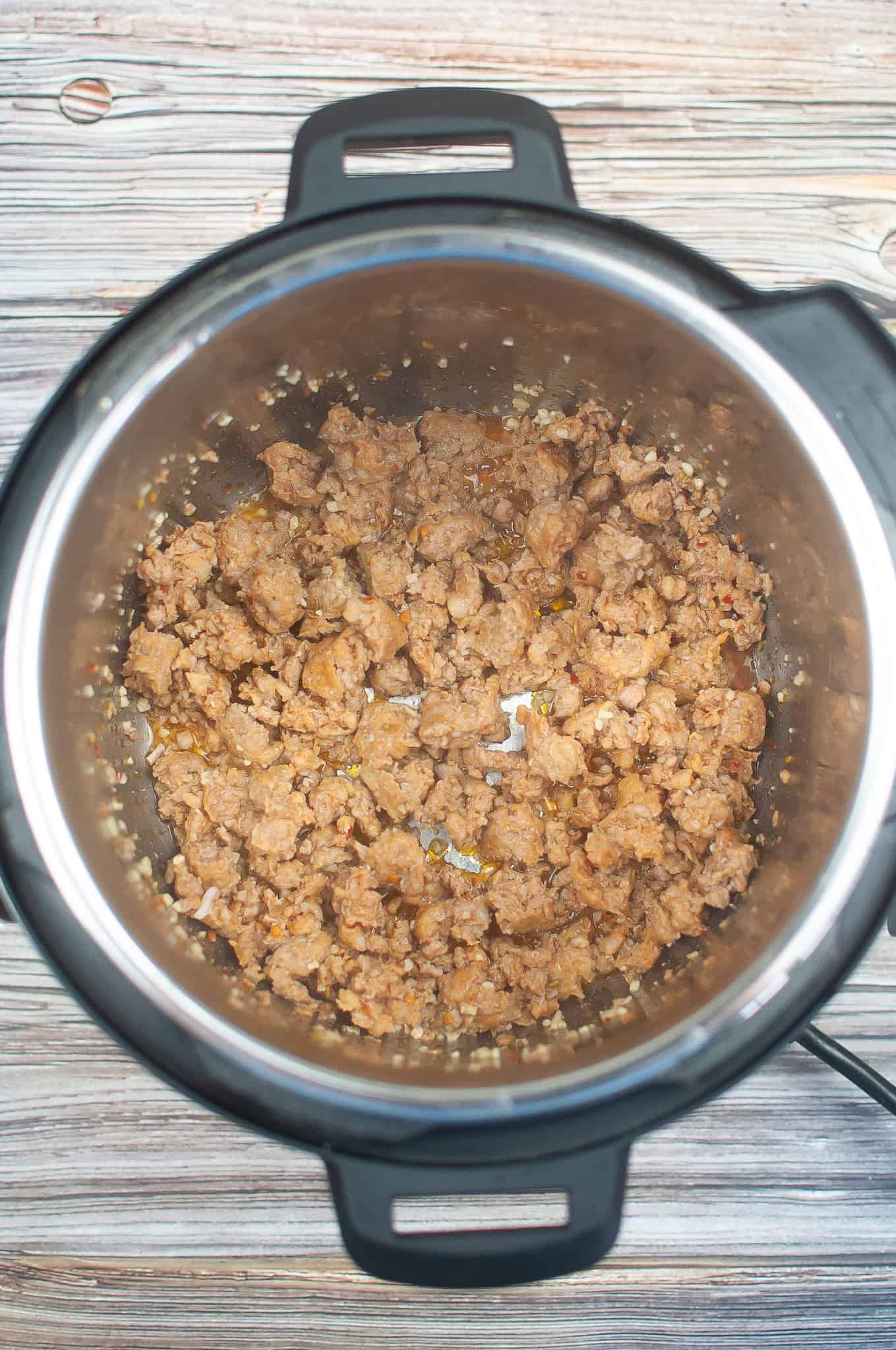 Overhead view of Instant Pot sausage browned in pot.