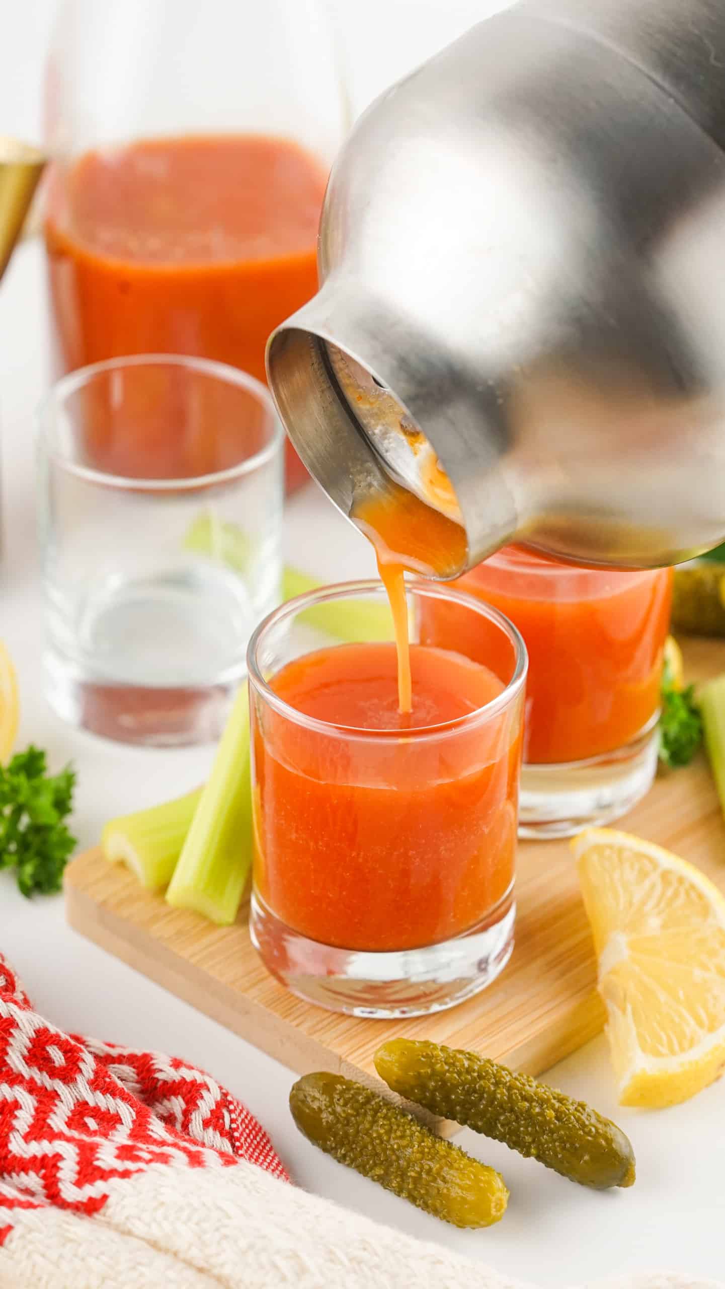 Pouring drink into shot glass.