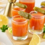 Tomato and pickle juice shots with pickle garnish.