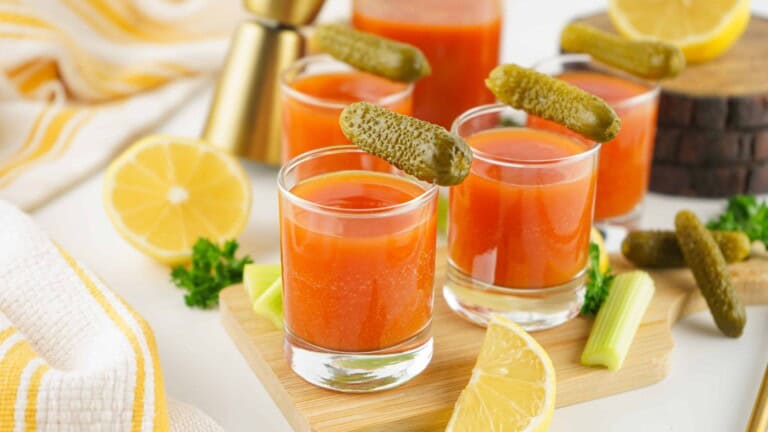 Tomato and pickle juice shots with pickle garnish.