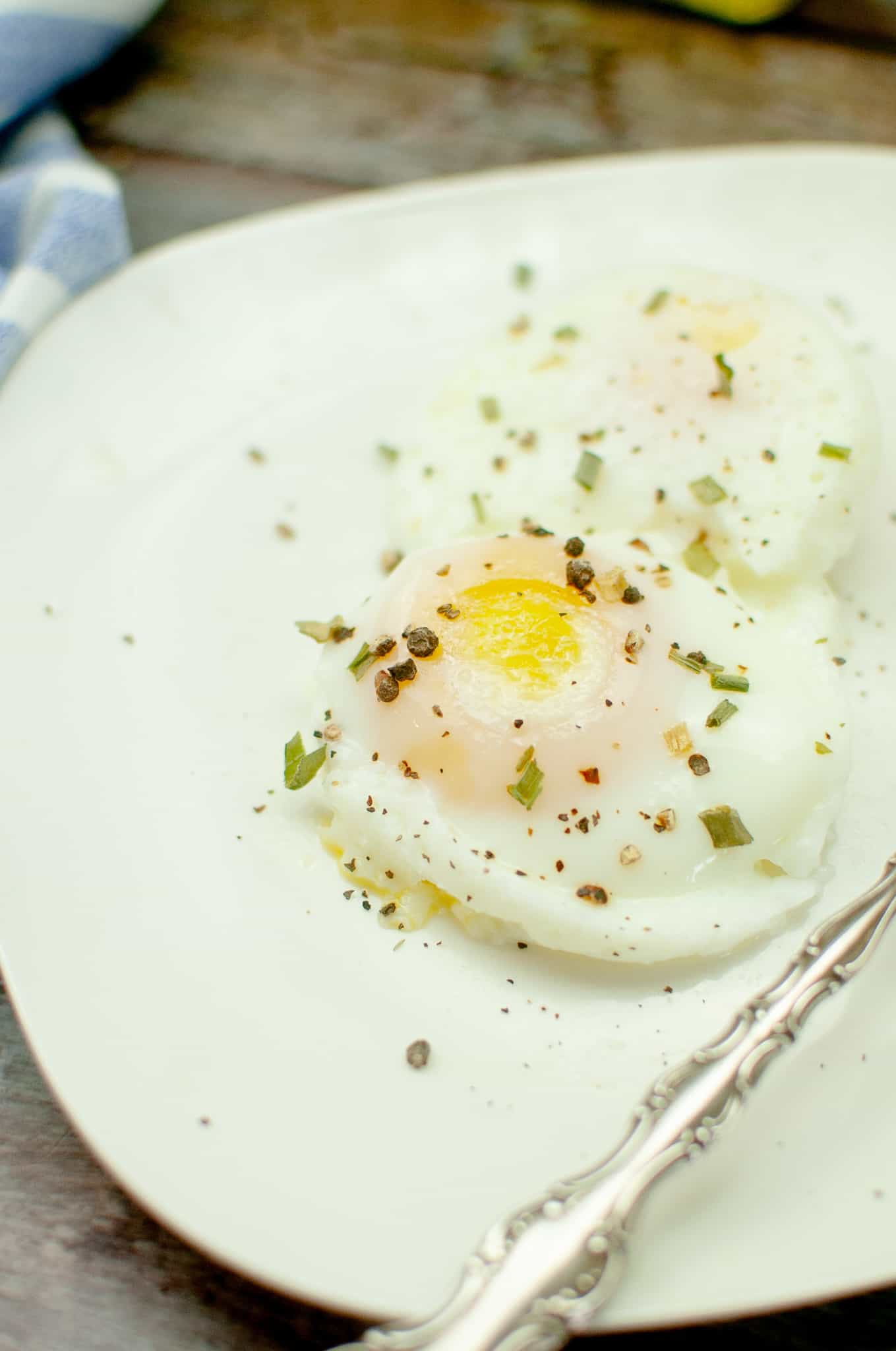 Closeup of poached egg on a white plate.