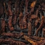 Overhead view of beef jerky in an air fryer basket.