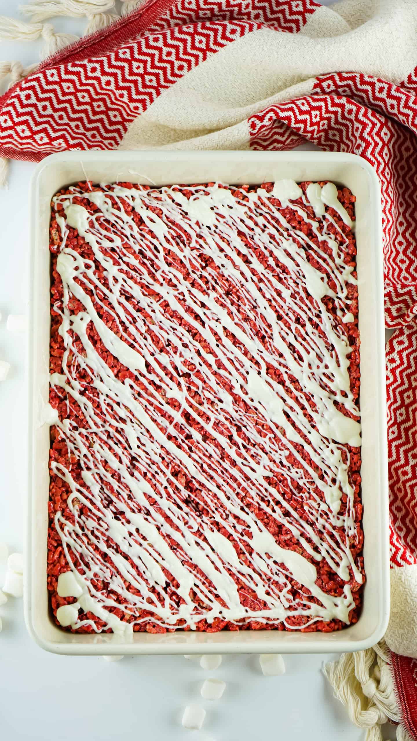 Overhead view of Red Velvet Rice Krispies with white chocolate drizzled on top.