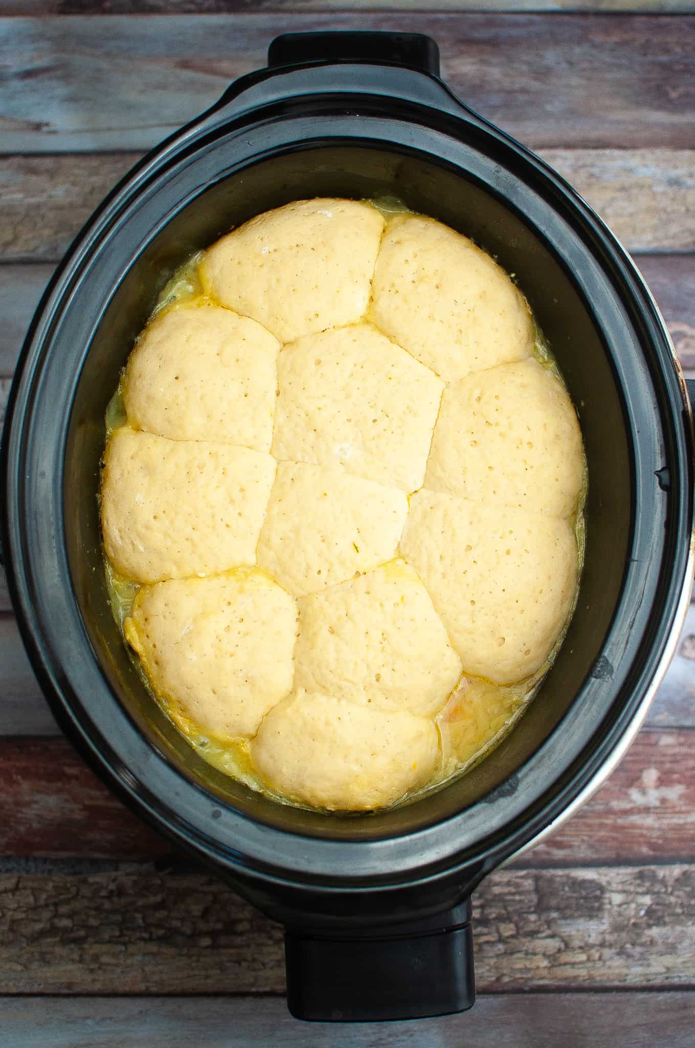 Overhead view of chicken and dumplings in crockpot.