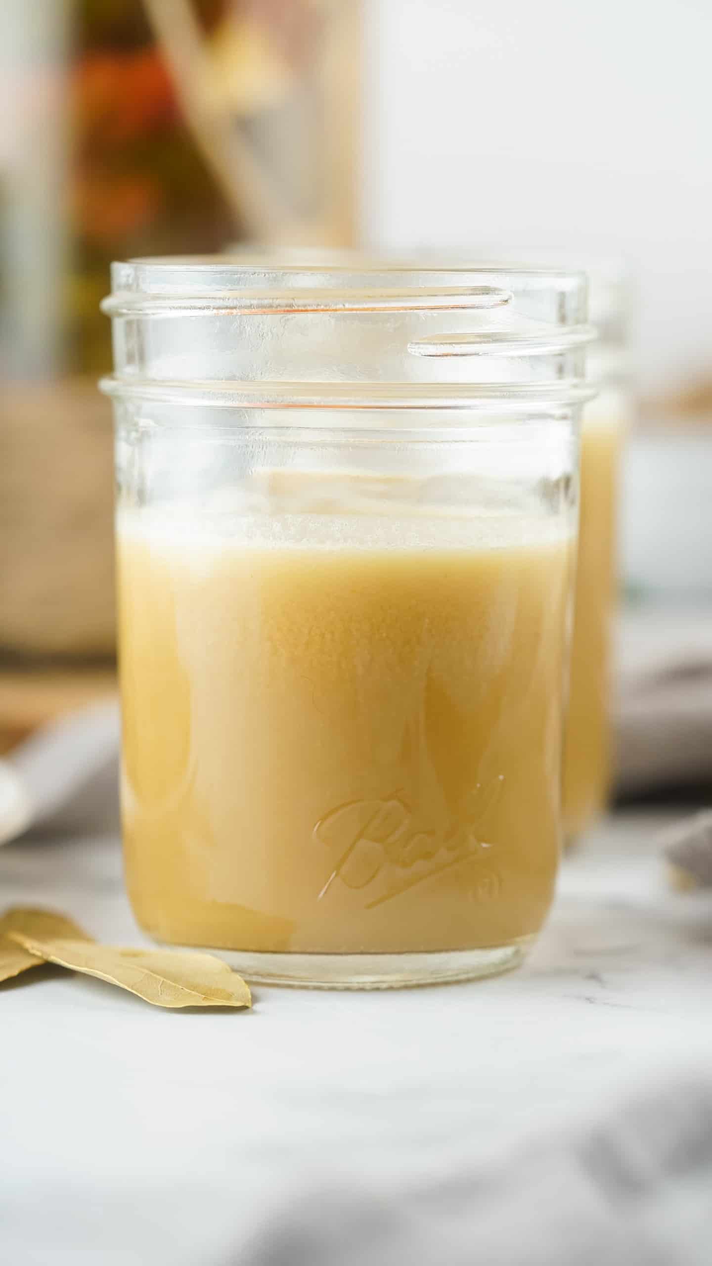 Headon view of Rotisserie Chicken Stock in a Mason jar.