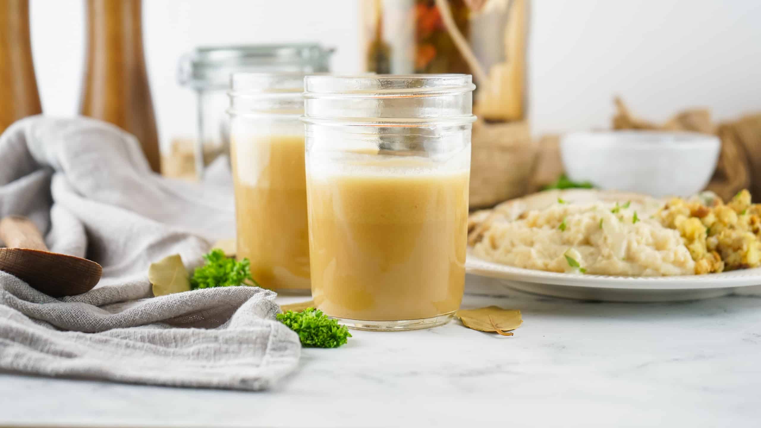 Headon view of Rotisserie Chicken Stock in Mason jars.