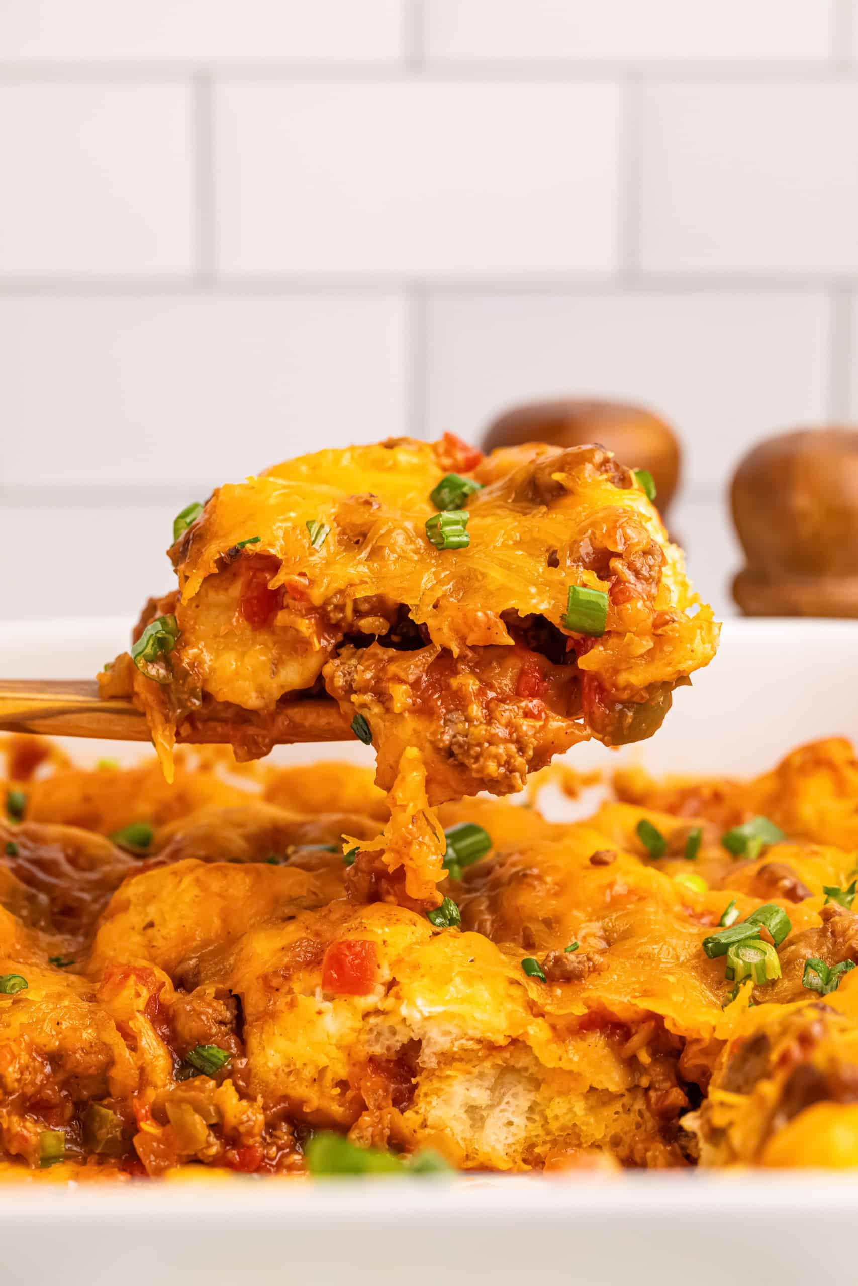 Scoop of taco bake out of casserole dish.