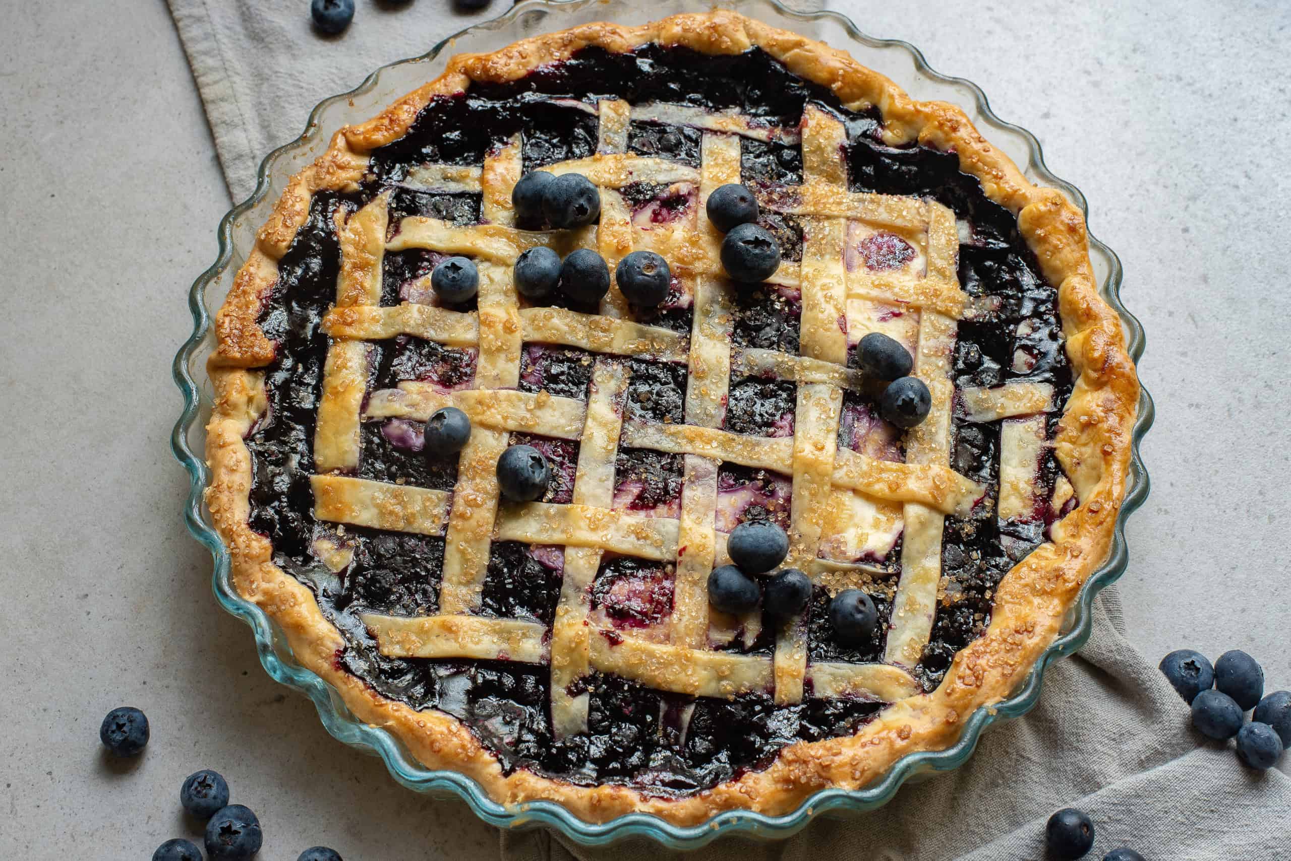 Overhead view of blueberry cream cheese pie with lattice top.
