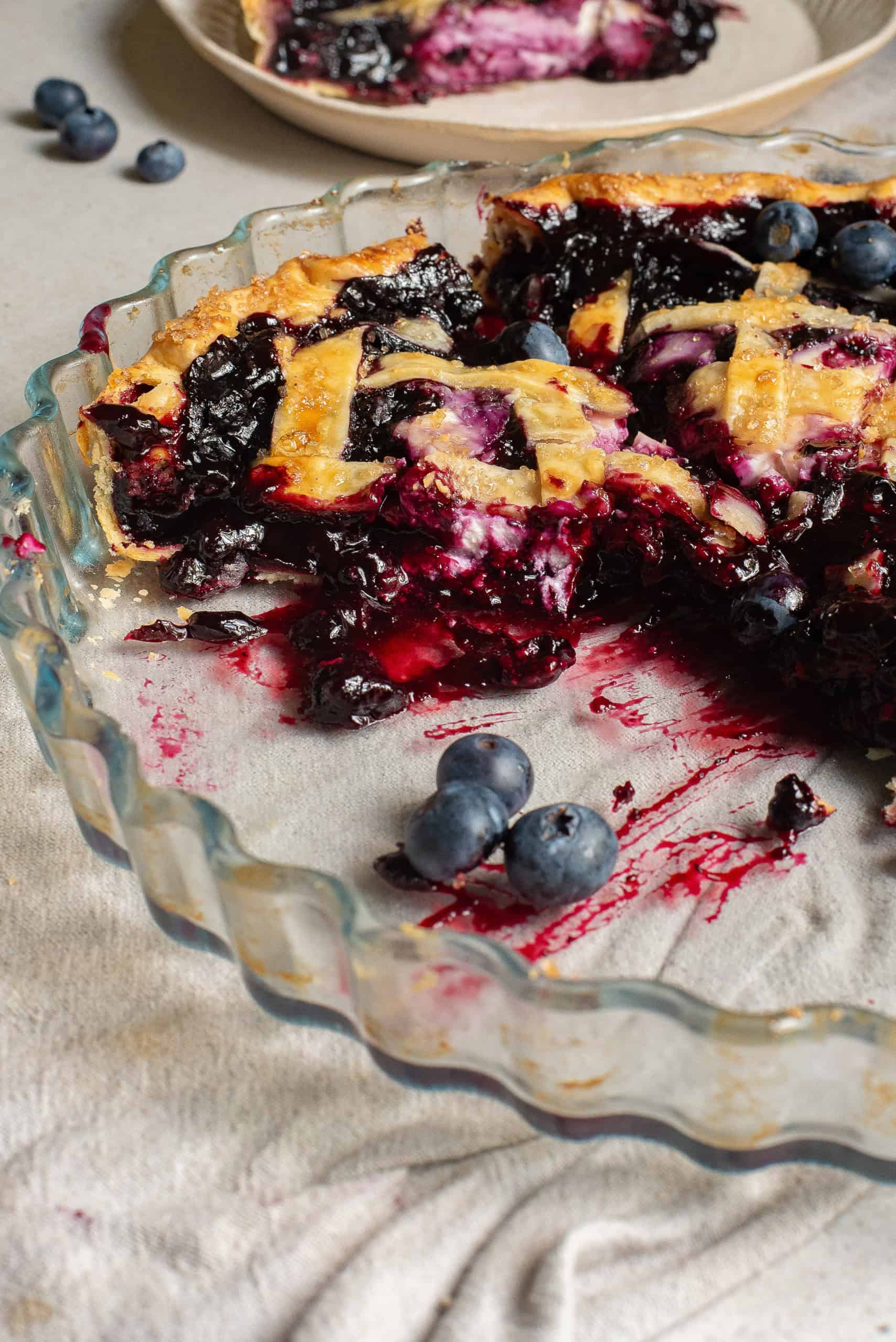 Cream Cheese Blueberry Pie with pieces cut out of it.