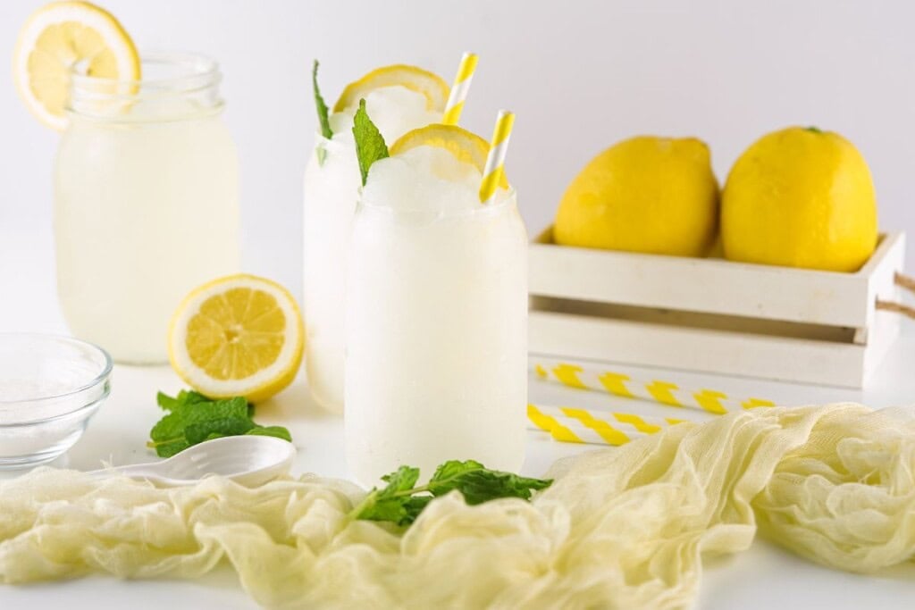 frozen lemonade slushies with lemon slices and mint