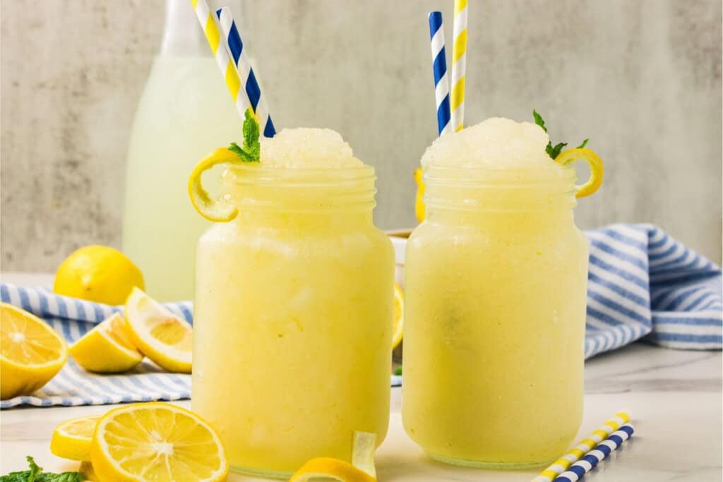 two lemonade slushies side-by-sdie with striped straws
