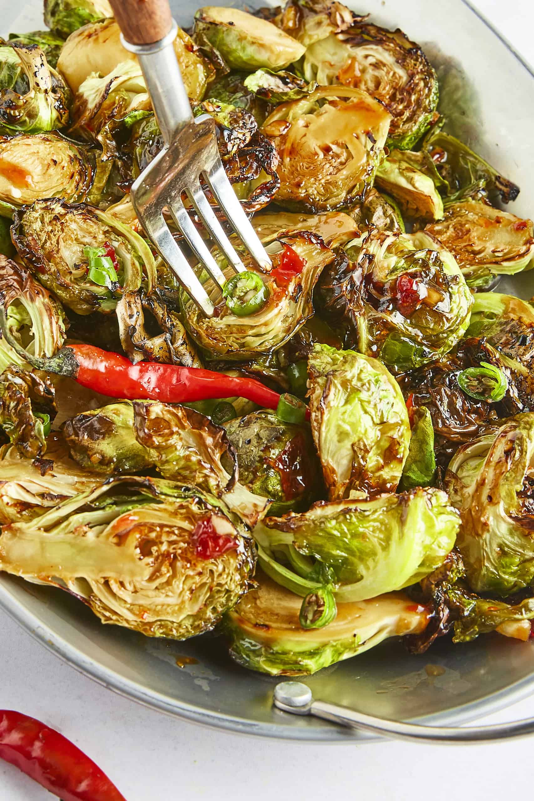 Air Fryer Sweet Chili Brussels Sprouts with a fork.