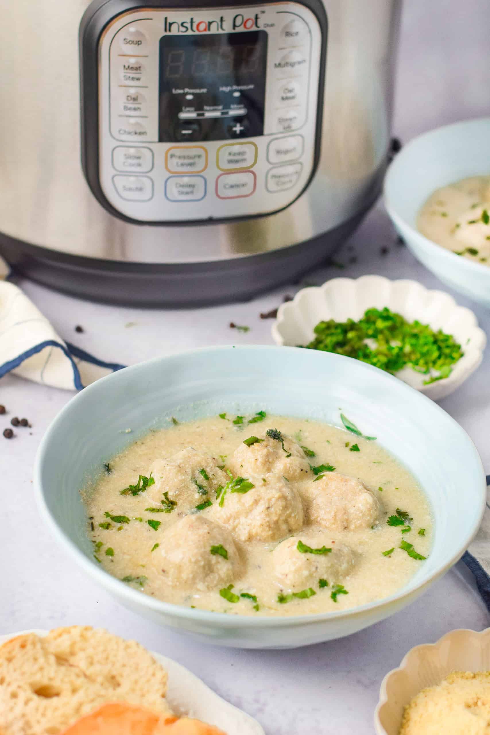 Chicken Alfredo Meatballs in front of Instant Pot.