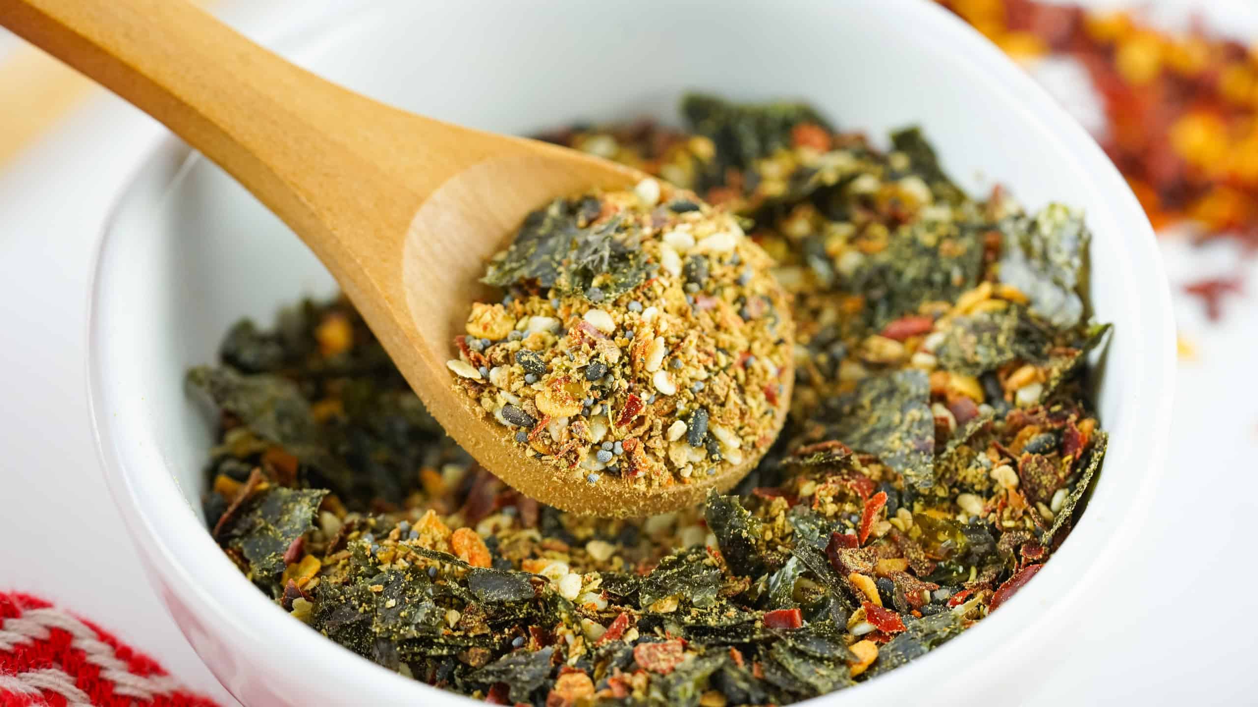 Shichimi Togarashi Blend in a white bowl with a wood measuring spoon.