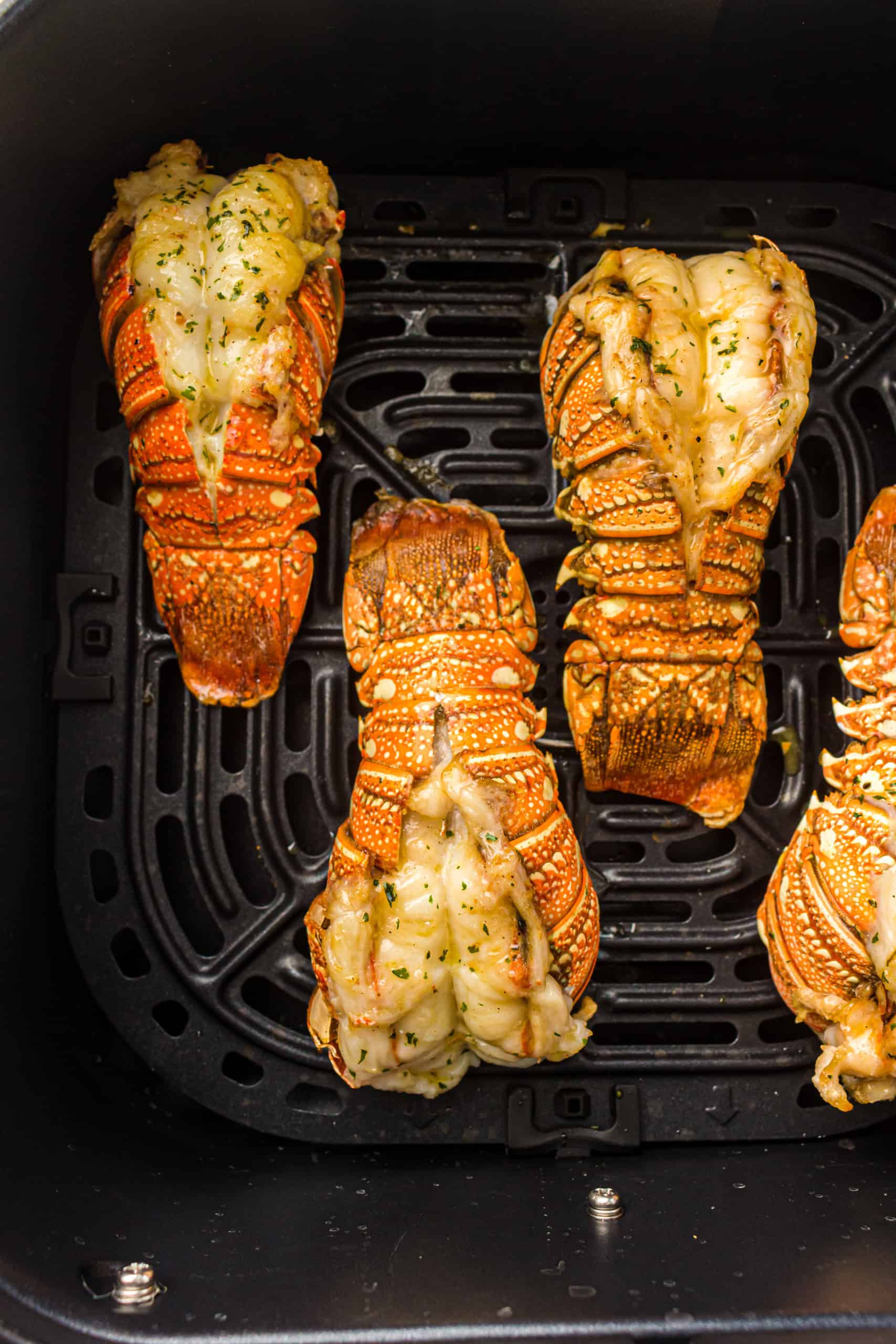 Overhead view of air fried lobster tails.