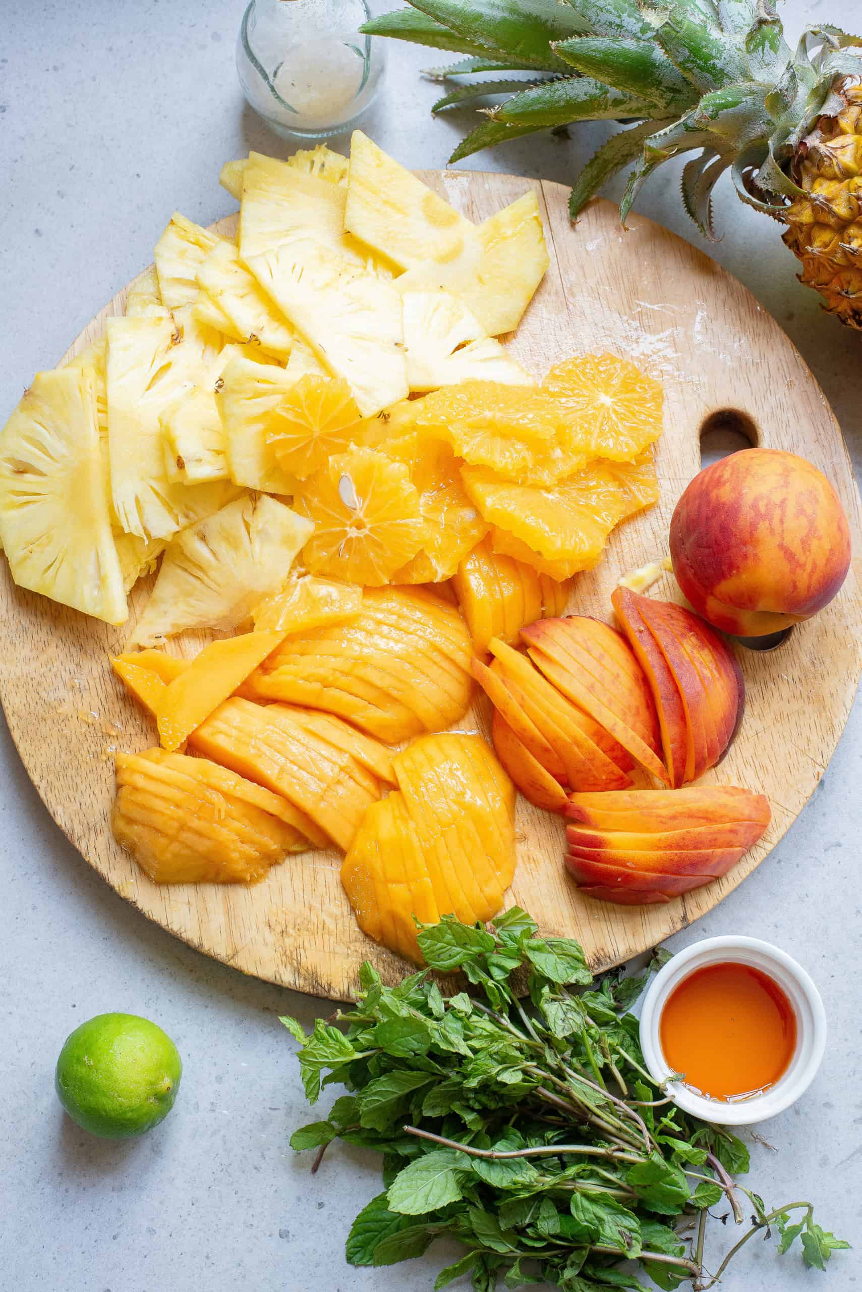 Overhead view of prepared ingredients for summer fruit salad.