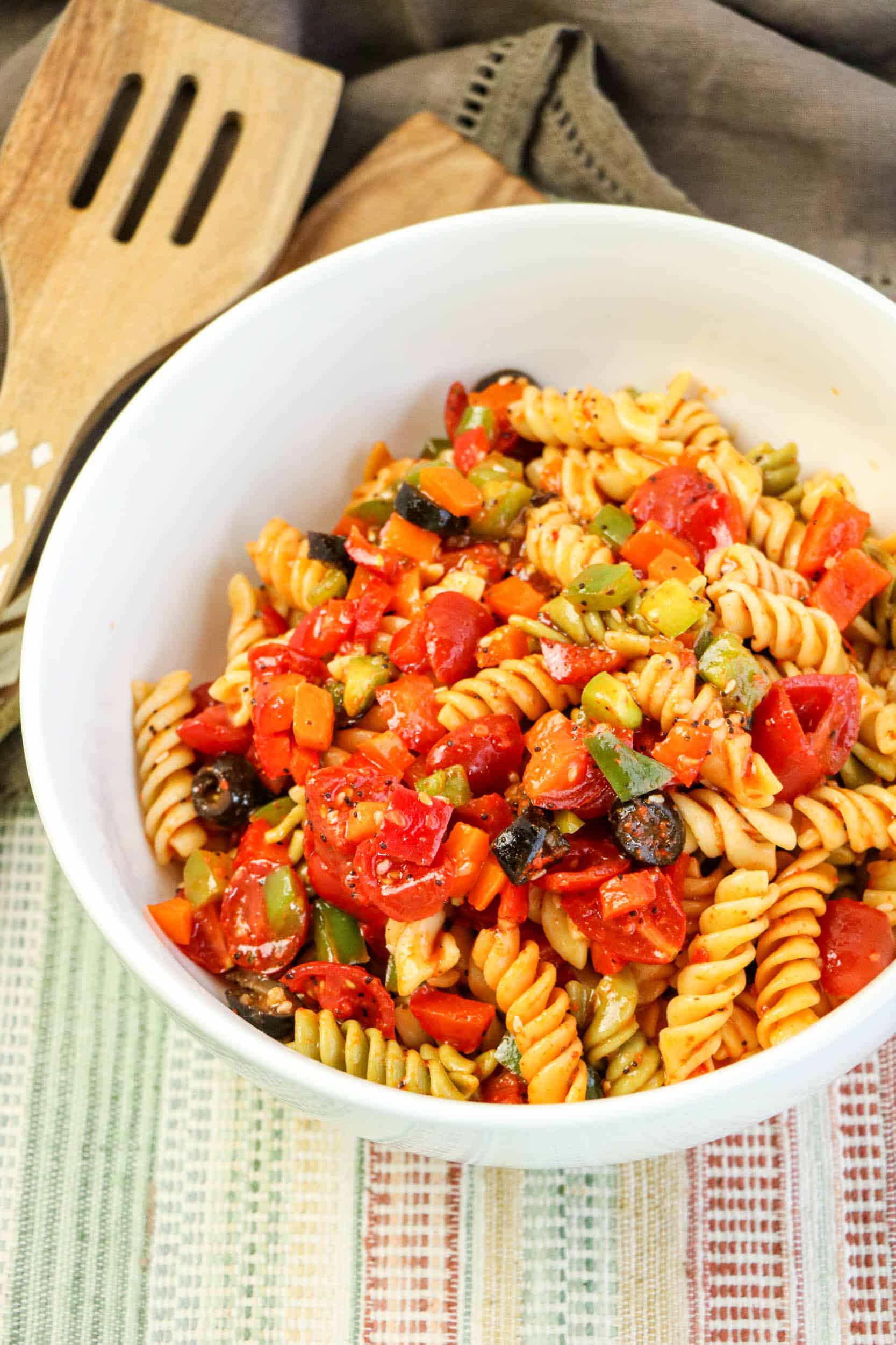 Overhead view of pasta salad in white bowl.