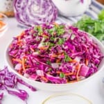 Red Cabbage Coleslaw in a white bowl.