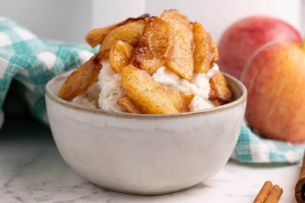 Air fryer apples served over vanilla ice cream.