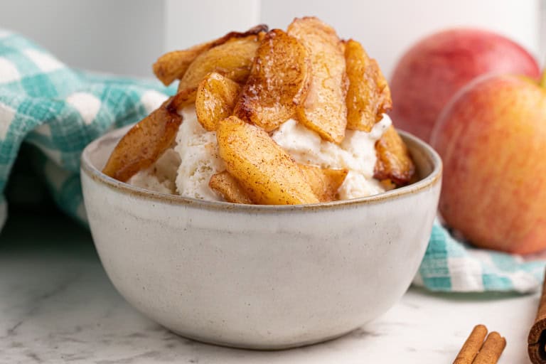 Air fryer apples served over vanilla ice cream.