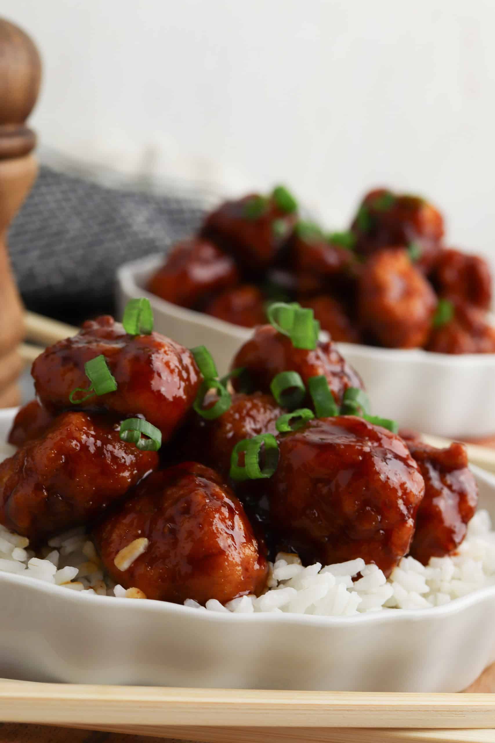 Closeup of General Tso's chicken over white rice.