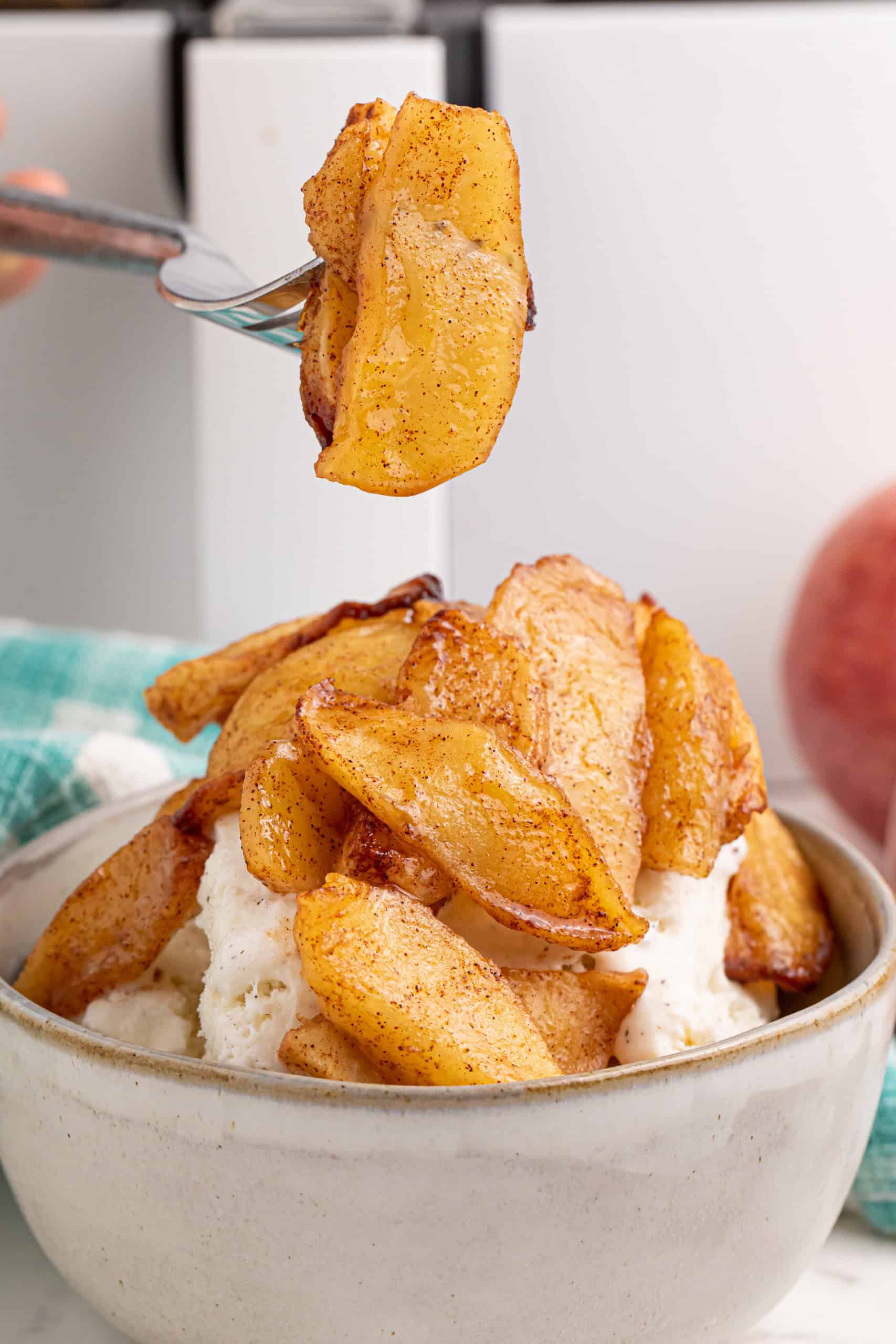 Air fried apples with cinnamon and sugar on a fork.