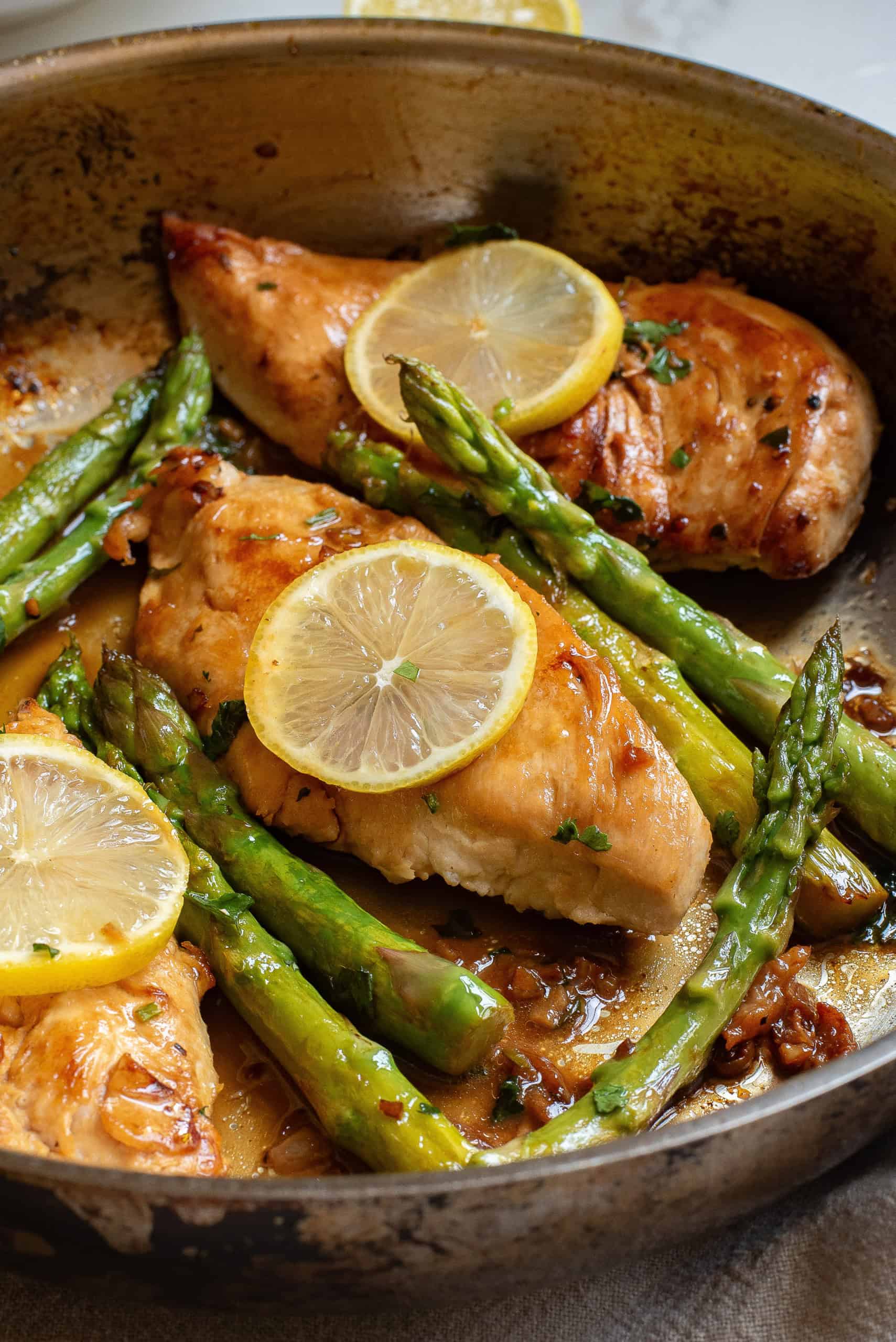Closeup of Chicken with lemon butter and asparagus.