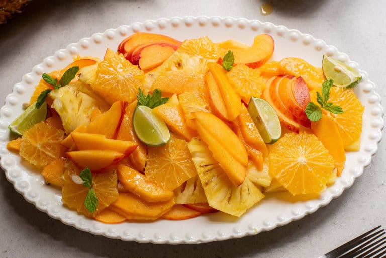 Plate for fresh fruit salad with honey lime mint dressing.