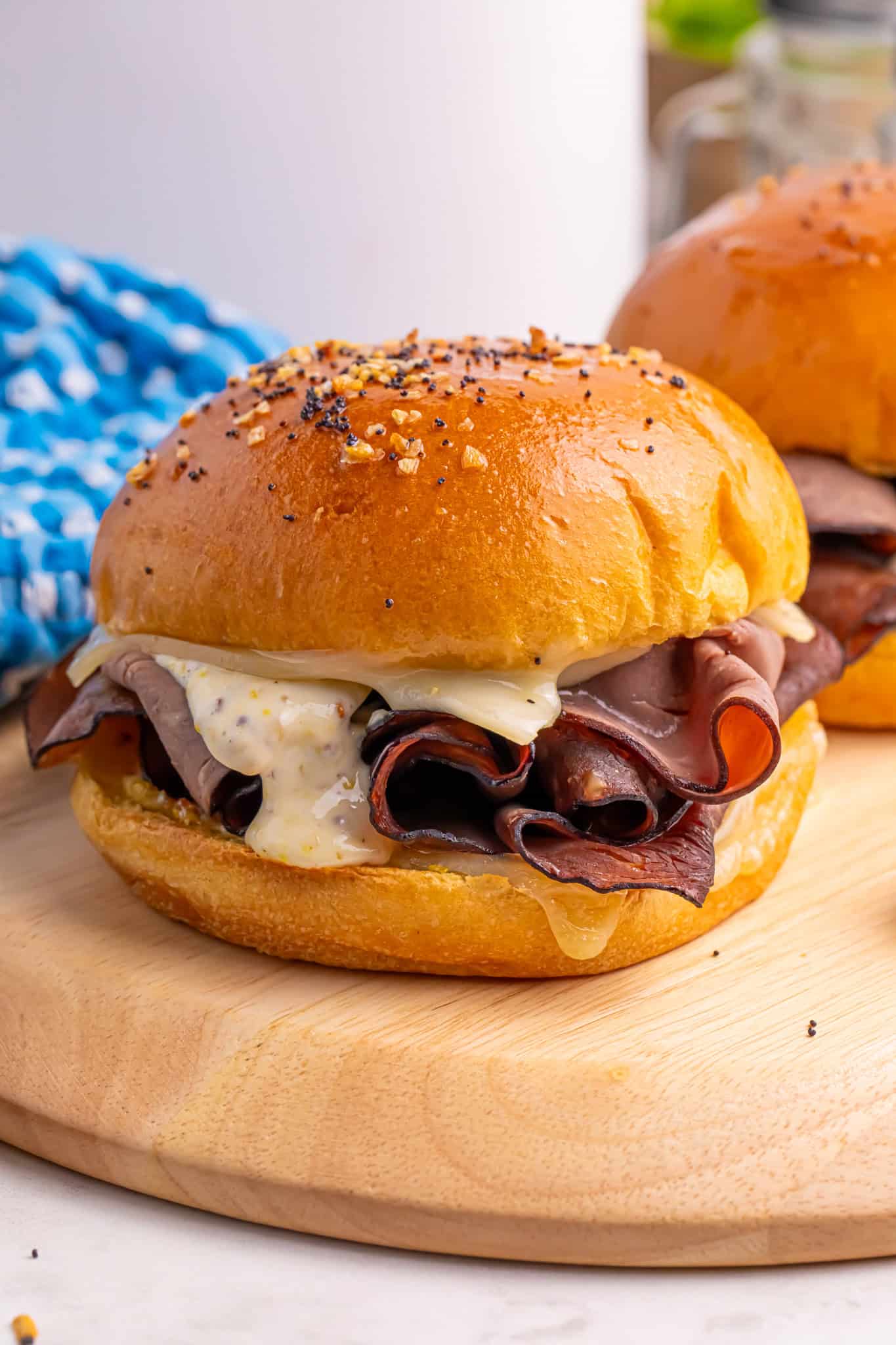 Swiss Beef Sandwichse on a wooden cutting board.