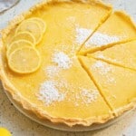 Overhead view of easy lemon tart with lemon slices and dusted with powdered sugar.
