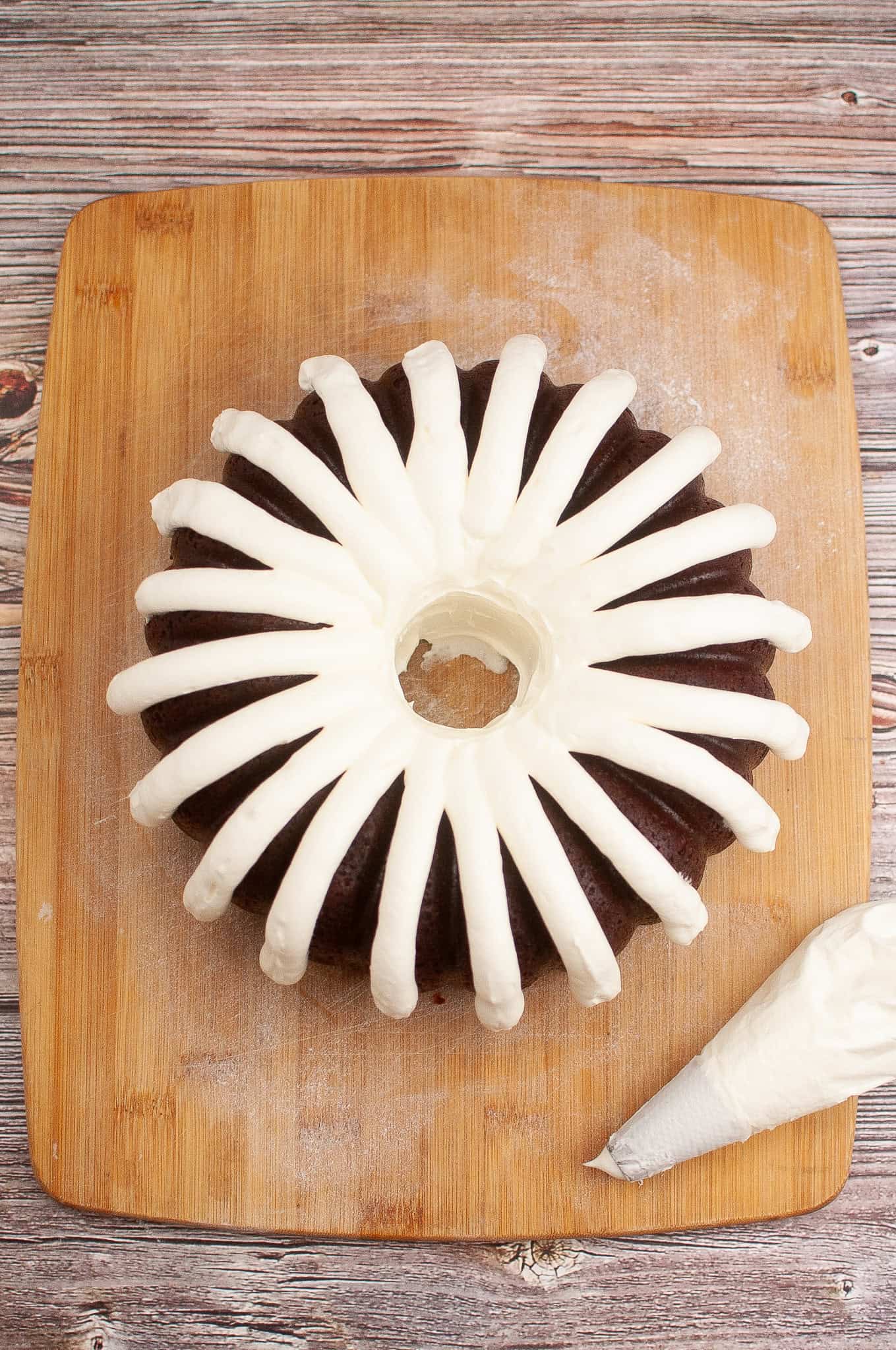 Red Velvet Bundt Cake Iced on cutting board.