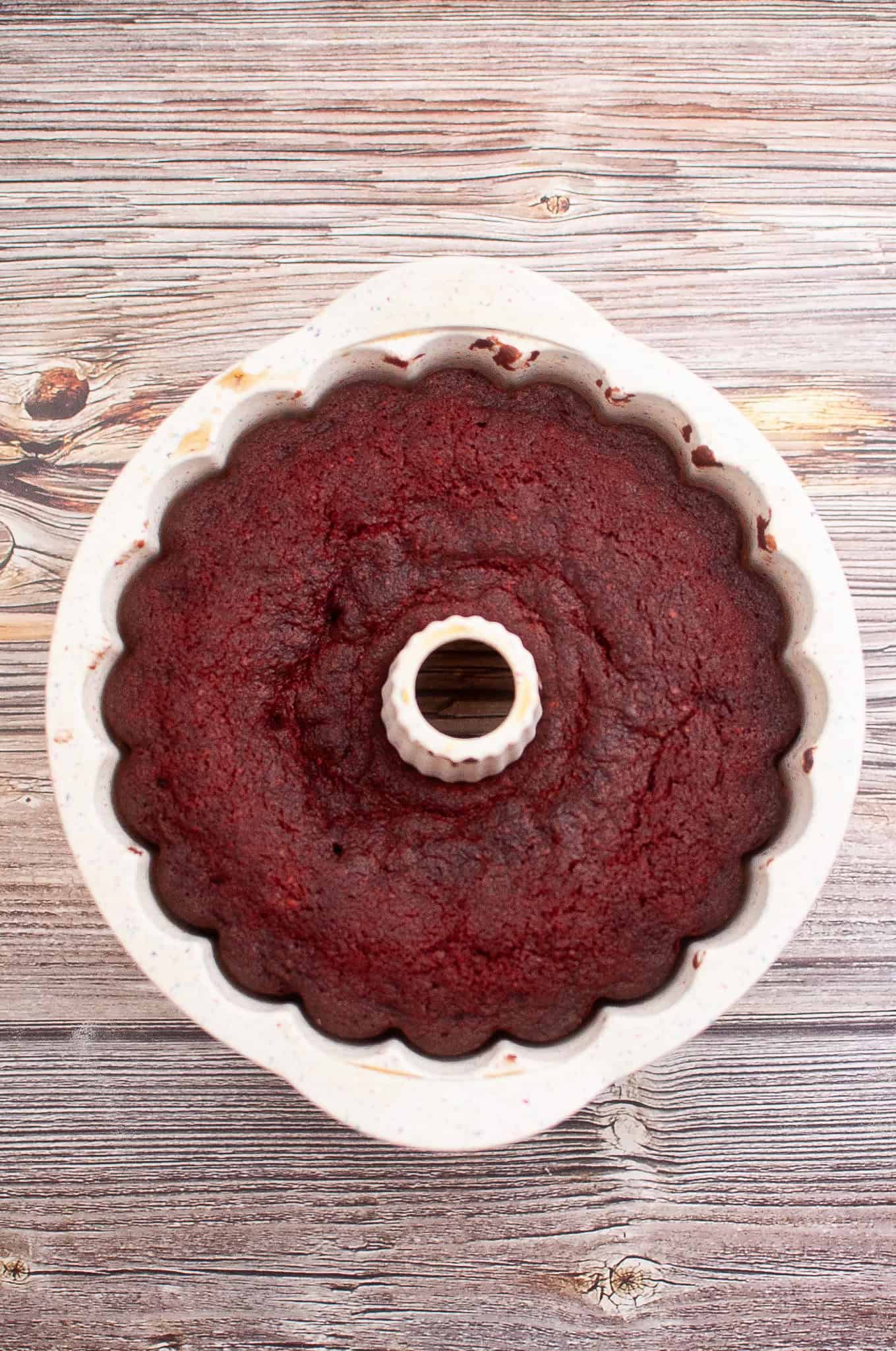 Overhead view of red velvet bundt cake in pan.