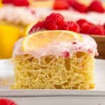 Slice of Lemon Raspberry Cake on a white plate.