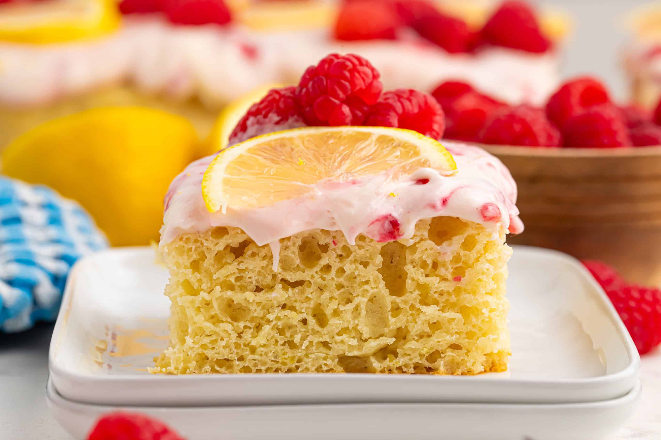 Slice of Lemon Raspberry Cake on a white plate.