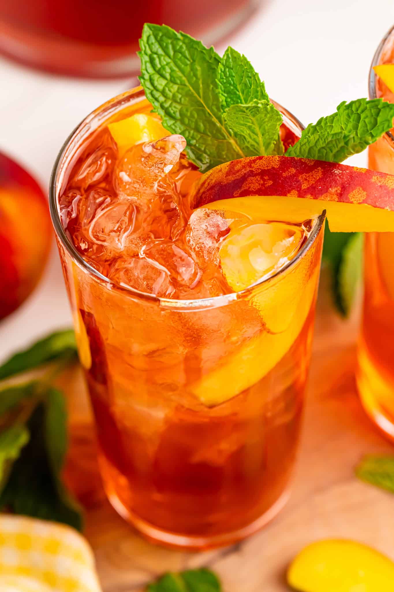 Overhead view of a glass of peach tea cocktail with rum.
