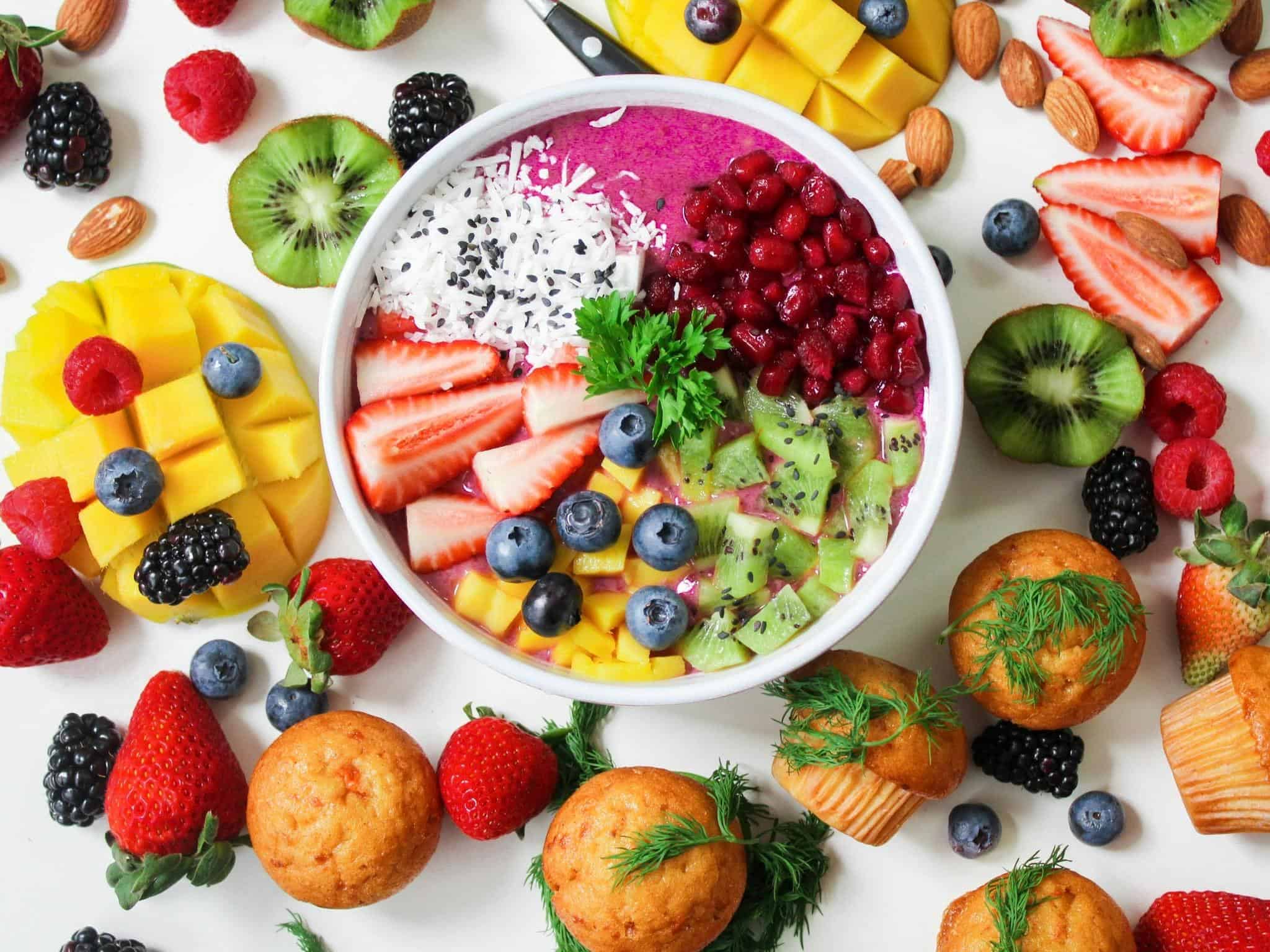 Overhead view of smoothie bowl with fruit on top of it.