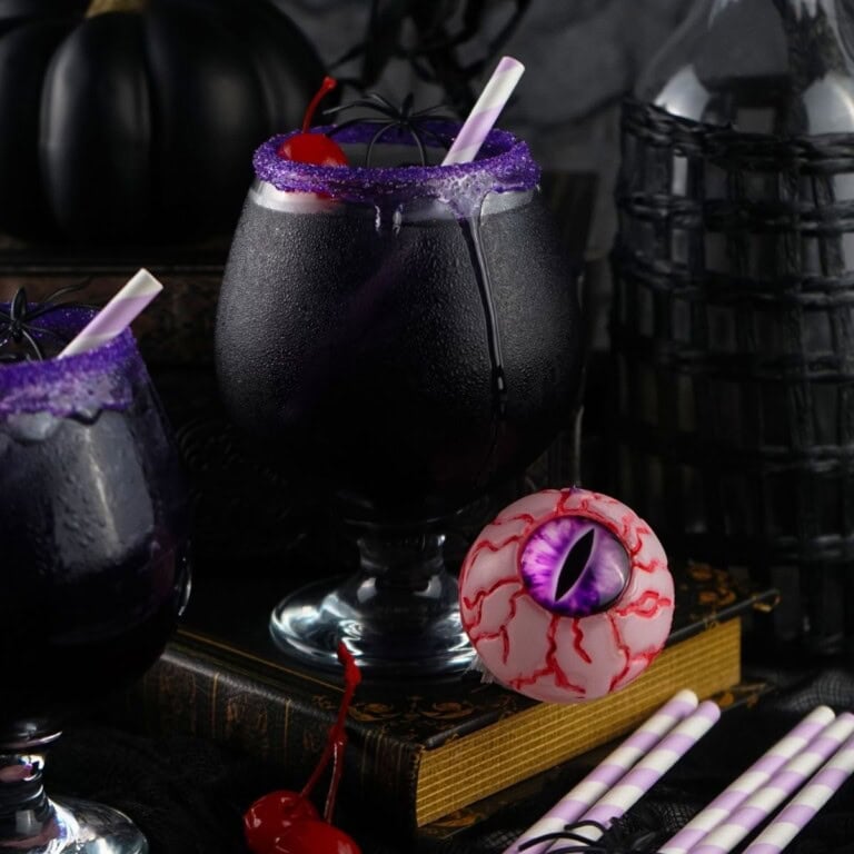 purple people eater drink with a straw and cherry in it