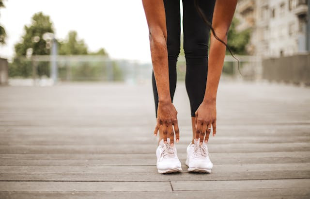 Woman bending over stretching for a run.