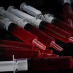 Syringe Jello Shots on a black background.