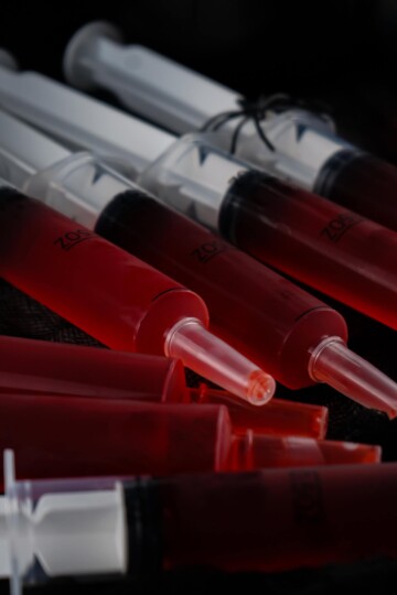 Syringe Jello Shots on a black background.