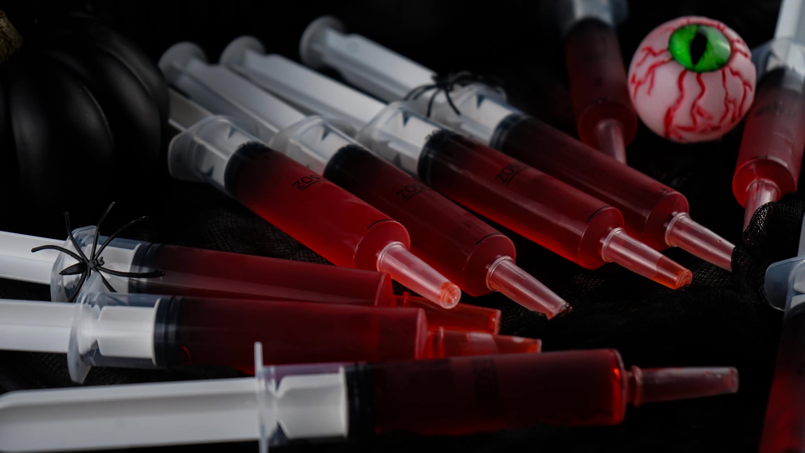 Syringe Jello Shots on a black background.